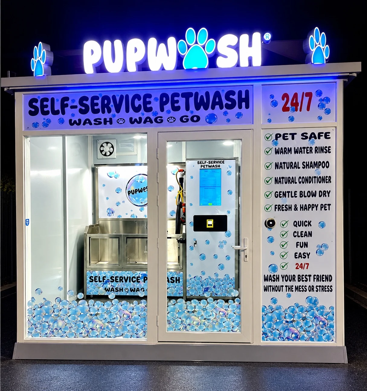 Pupwash kiosk illuminated at night